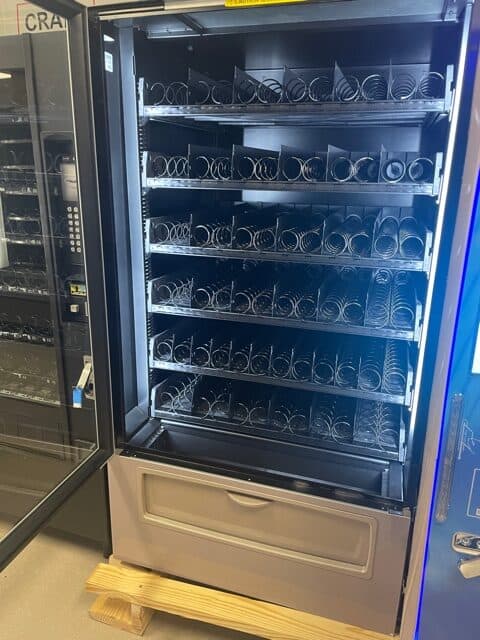 CRANE Merchant 6 Media Ambient, model 187 vending machine inside storage