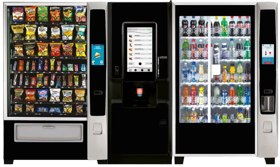 Photo of a bank of modern vending machines with snack machine, coffee machine, and cold drink machine